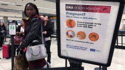 Woman looks at CDC sign