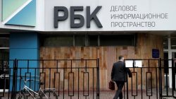 Man walks towards RBC media group office building in Moscow