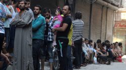 People queue for bread in the rebel held al-Shaar neighbourhood of Aleppo