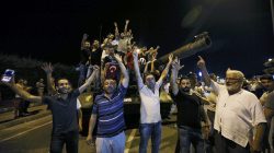 People stand on a Turkish army tank at Ataturk airport in Istanbul, Turkey July 16, 2016.