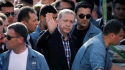 Turkish President Recep Tayyip Erdogan waves to the crowd following a funeral service for a victim of the thwarted coup in Istanbul