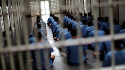 Inmates sit on the floor during an inspection visit in the long term sentence zone inside Klong Prem high-security prison in Bangkok,