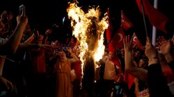 Supporters of Turkish President Tayyip Erdogan shout slogans over a burning effigy of U.S.-based cleric Fethullah Gulen during a pro-government demonstration at Taksim Square in Istanbul, Turkey