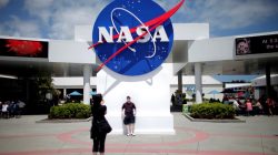 ourists take pictures of a NASA sign at the Kennedy Space Center visitors complex in Cape Canaveral, Florida