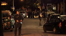 Police stand in a small street following a shooting rampage at the Olympia shopping mall in Munich, Germany