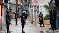 Security block a road where police are taking down militants
