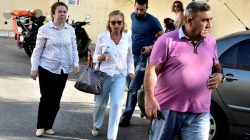 Turkish journalist Nazli Ilicak is escorted by a police officer and her relatives after being detained and brought to a hospital for a medical check in Bodrum