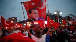 A supporter holds a flag depicting Turkish President Tayyip Erdogan during a pro-government demonstration in Ankara, Turkey