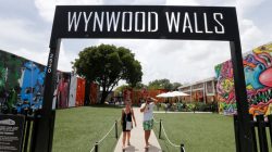 Visitors walk through the Wynwood arts district of Miami