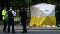 Police officers stand near a forensics tent after a knife attack in Russell Square in London