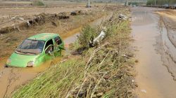 A wrecked car is seen after heavy floods in Cento