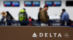 Passengers check in at a counter of Delta Air Lines in Mexico City, Mexico, August 8, 2016.