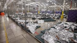 Detainees sleep and watch television in a holding cell where hundreds of mostly Central American immigrant children are being processed and held at the U.S. Customs and Border Protection