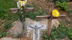 Wooden crosses for an unmarked refugee grave