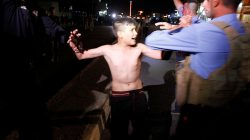Iraqi security forces detain a boy after removing a suicide vest from him in Kirkuk