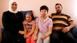 Muhammed Mazin Mekansi poses with his family at their home in Ankara