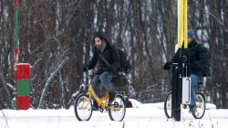 Two migrants on bicycles cross the border between Norway and Russia in Storskog near Kirkenes in Northern Norway