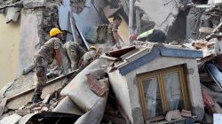 Rescuers work at a collapsed building following an earthquake in Amatrice