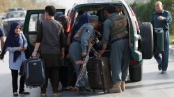 tudents walk toward a police vehicle after they were rescued from the site of an attack at the American University of Afghanistan in