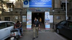 An employee walks out of the State Bank of India main branch in Mumbai, India,