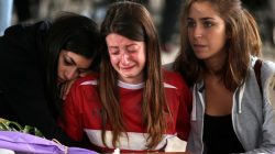 Mourners cry next to a coffin prior the funeral for victims of the earthquake that leveled the town in Amatrice
