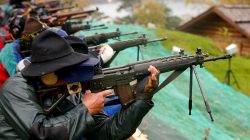 Participants fire their infantry and assault rifles during the traditional 'Ruetlischiessen' (Ruetli shooting) competition at the Ruetli meadow in central Switzerland