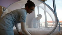 Nurses set up a mosquito tent over a hospital bed, as part of a precautionary protocol for patients who are infected by Zika, to show the media at Farrer Park