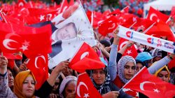 People wave national flags as they wait for Turkey's President Erdogan arrival to the United Solidarity and Brotherhood rally in Gaziantep