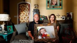 Kelly and Ryan Breaux sit holding a portrait of their deceased daughter Emma Breaux in their home in Breaux Bridge, Louisiana, on June 16, 2016. The husband and wife lost twins, Emma and Talon, to different superbugs that they contracted while in the neonatal unit at Lafayette General Hospital.