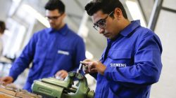 Refugees show their skills in metal processing works during a media tour at a workshop for refugees organized by German industrial group Siemens in Berlin, Germany,