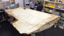 Australian and Malaysian officials examine aircraft debris at the Australian Transport Safety Bureau headquarters in Canberra, Australia, after it was found on Pemba Island, located near Tanzania, in late June.