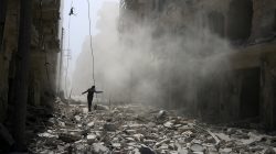 A man walks on the rubble of damaged buildings after an airstrike on the rebel held al-Qaterji neighbourhood of Aleppo, Syria September 25, 2016.