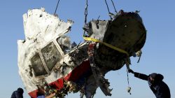Local workers transport a piece of the Malaysia Airlines flight MH17 wreckage at the site of the plane crash near the village of Hrabove (Grabovo) in Donetsk region, eastern Ukraine