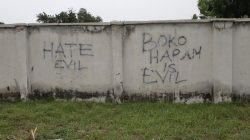 Writings describing Boko Haram are seen on the wall along a street in Bama, in Borno, Nigeria