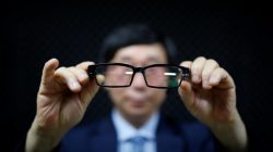 Moon Seoung-ok, president of the Headquarters of Reporting for Public Good, poses for photographs as he demonstrates a glasses shaped spycam during a class in Seoul, South Korea,