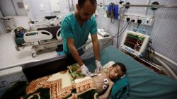 A nurse checks a boy at a hospital intensive care unit in Sanaa, Yemen