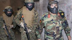 Brig. Gen. Muhaiuddin Ghori, commanding general, 3rd Kandak, 205th Corps, Afghan National Army, maneuvers alongside a Marine fire team on patrol in a virtual village in the infantry immersion trainer during a visit at U.S. Marine Corps Base Camp Pendleton in California,