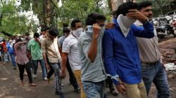 Police escort men who they said were arrested on Wednesday on suspicion of tricking American citizens into sending them money by posing as U.S. tax officials, at a court in Thane, on the outskirts of Mumbai, India,