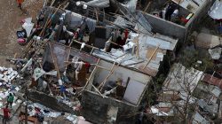 People try to rebuild their destroyed houses after Hurricane Matthew passes Jeremie, Hait