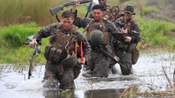 U.S. military forces cross a flooded area near the shore during the annual Philippines-US amphibious landing exercise (PHIBLEX) at San Antonio, Zambales province, Philippines
