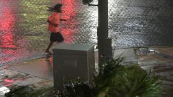 A pedestrian runs across a street as the eye of Hurricane Matthew approaches Daytona Beach, Florida,