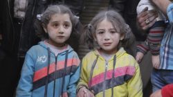 Girls who survived what activists said was a ground-to-ground missile attack by forces of Syria's President Bashar al-Assad, hold hands at Aleppo's Bab al-Hadeed