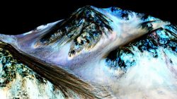 Dark, narrow, 100 meter-long streaks on Mars inferred to have been formed by contemporary flowing water are seen in a NASA handout image
