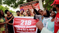 Members of the #BringBackOurGirls (#BBOG) campaign stand behind a banner with Number 218 during a sit-out in Abuja, Nigeria May 18, 2016, after receiving news that a Nigerian teenager kidnapped by Boko Haram from her school in Chibok more than two years ago has been rescued.