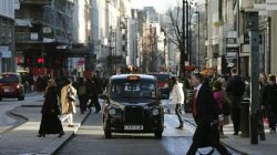 A taxi travels along Oxford Street during a bus strike in London January 13, 2015. Members of the Unite union are staging a 24-hour bus strike over pay and conditions, local media reported.