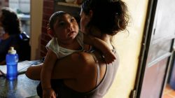 Ericka Torres holds her 3-months old son Jesus, who was born with microcephaly, at their home in Guarenas, Venezuela