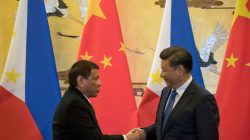 Philippine President Rodrigo Duterte (L) and Chinese President Xi Jinping shake hands after a signing ceremony held in Beijing, China
