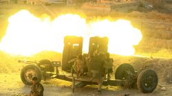 Peshmerga forces fire an anti-aircraft gun towards Islamic state militants positions in the town of Naweran near Mosul, Iraq