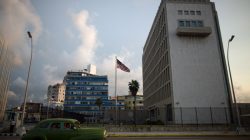 A vintage car passes by the U.S. Embassy in Havana, Cuba,