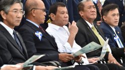 Philippine President Rodrigo Duterte (C), accompanied by Transportation Secretary Arthur Tugade (2nd R) and Defense Secretary Delfin N Lorenzana (2nd L), watches Japan's coast guard drills in Yokohama, Japan